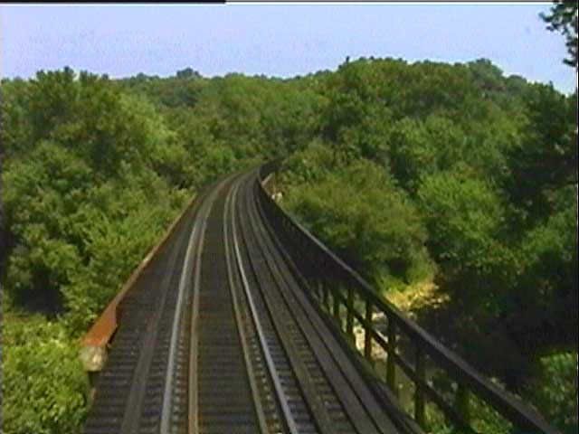 Rounding a curve and heading out over a trestle that spans a spectacular gorge.