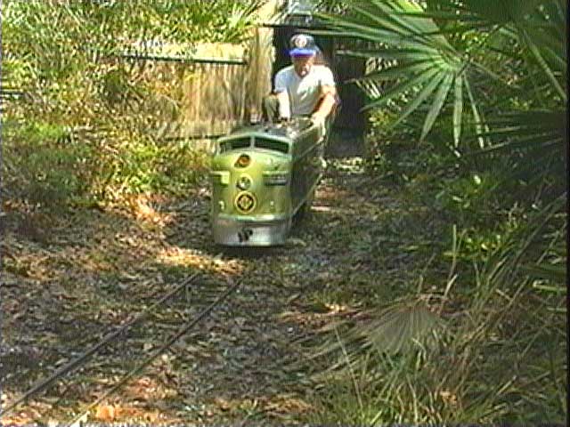 A diesel emerges from a dark tunnel on the Possum Flats and Eastern layout near Orlando.